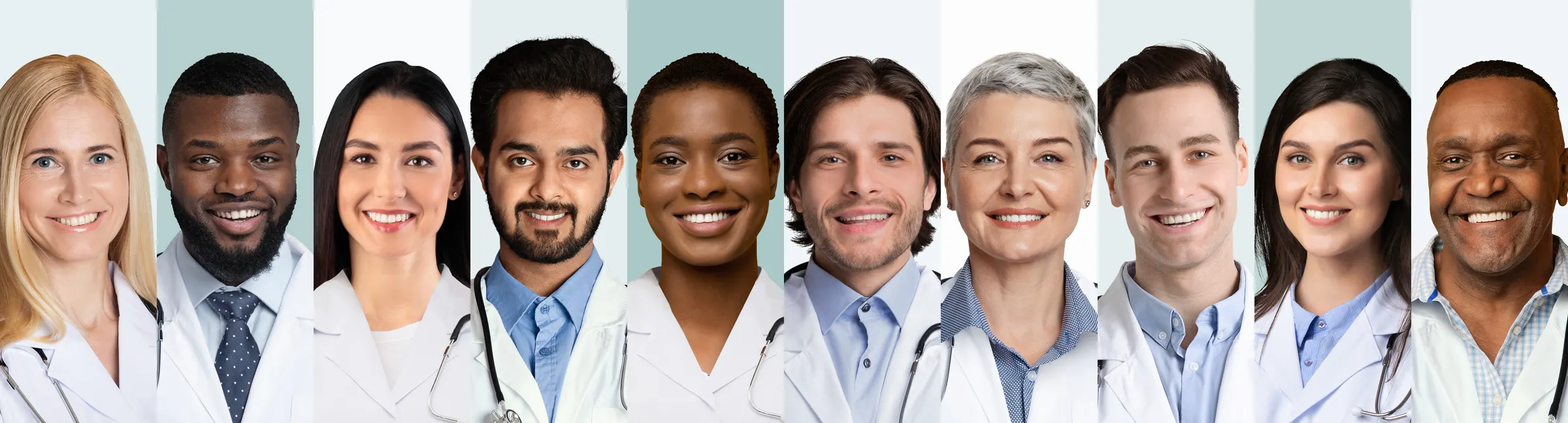 A row of smiling healthcare professionals in scrubs and white coats.